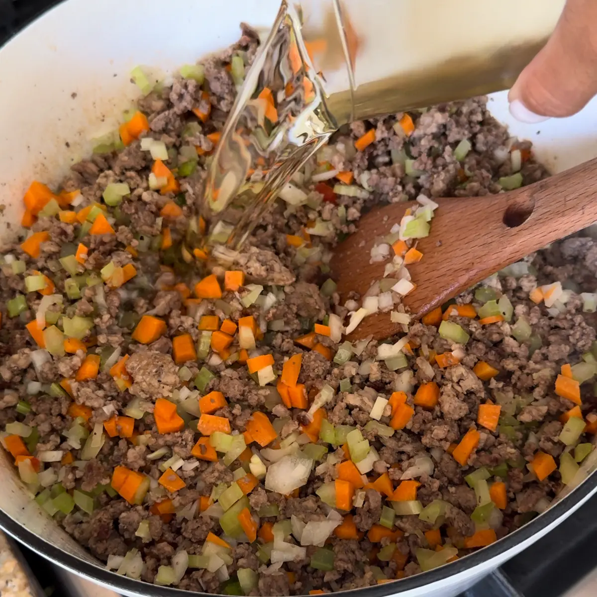 add wine, spices, tomato paste to ragu