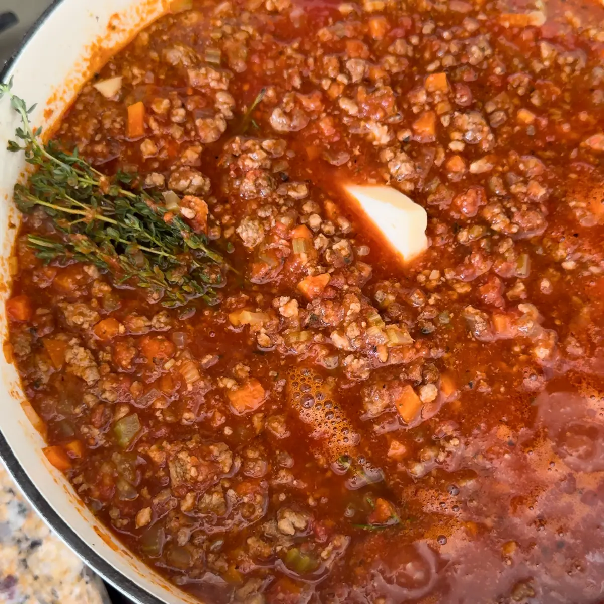 bouquet garni and parmesan rind to the ragu
