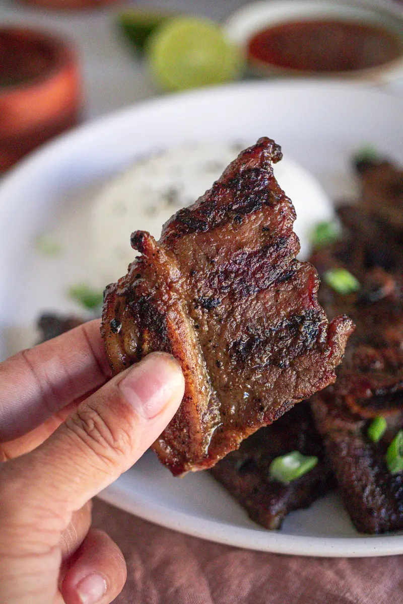 Close up image of grilled short ribs cooked in marinade