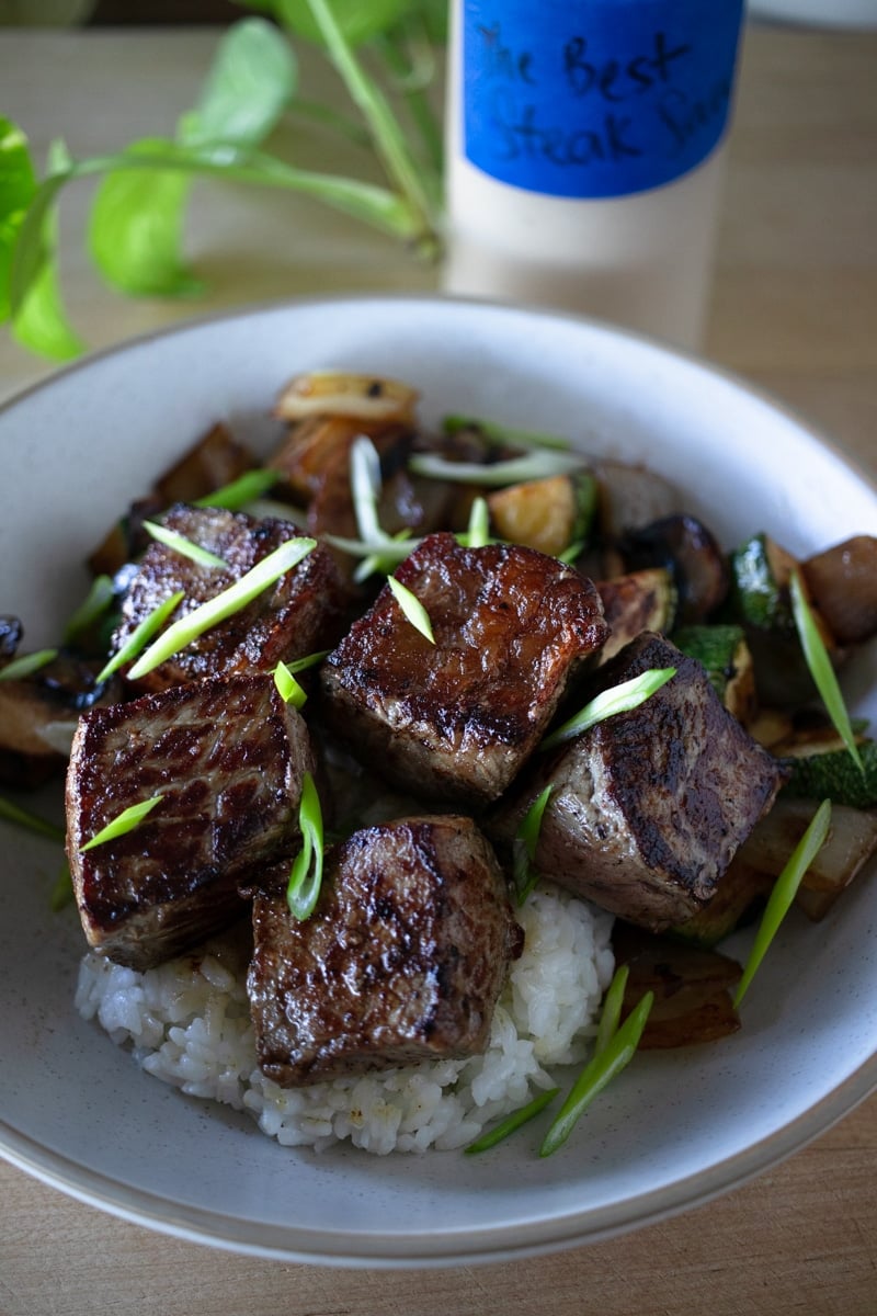 Hibachi steak rice bowl with rice, sauteed veggies and steak sauce. 