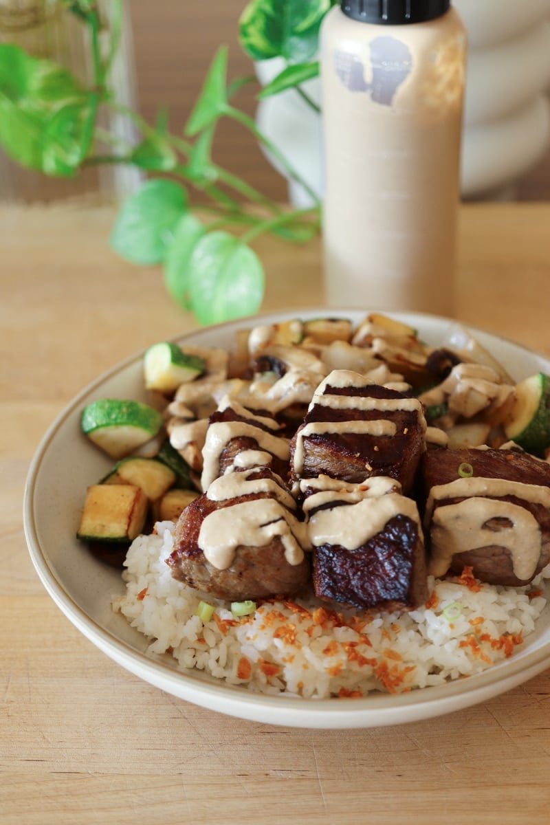 hibachi steak rice bowl with japanese steak sauce, rice and vegetables. 