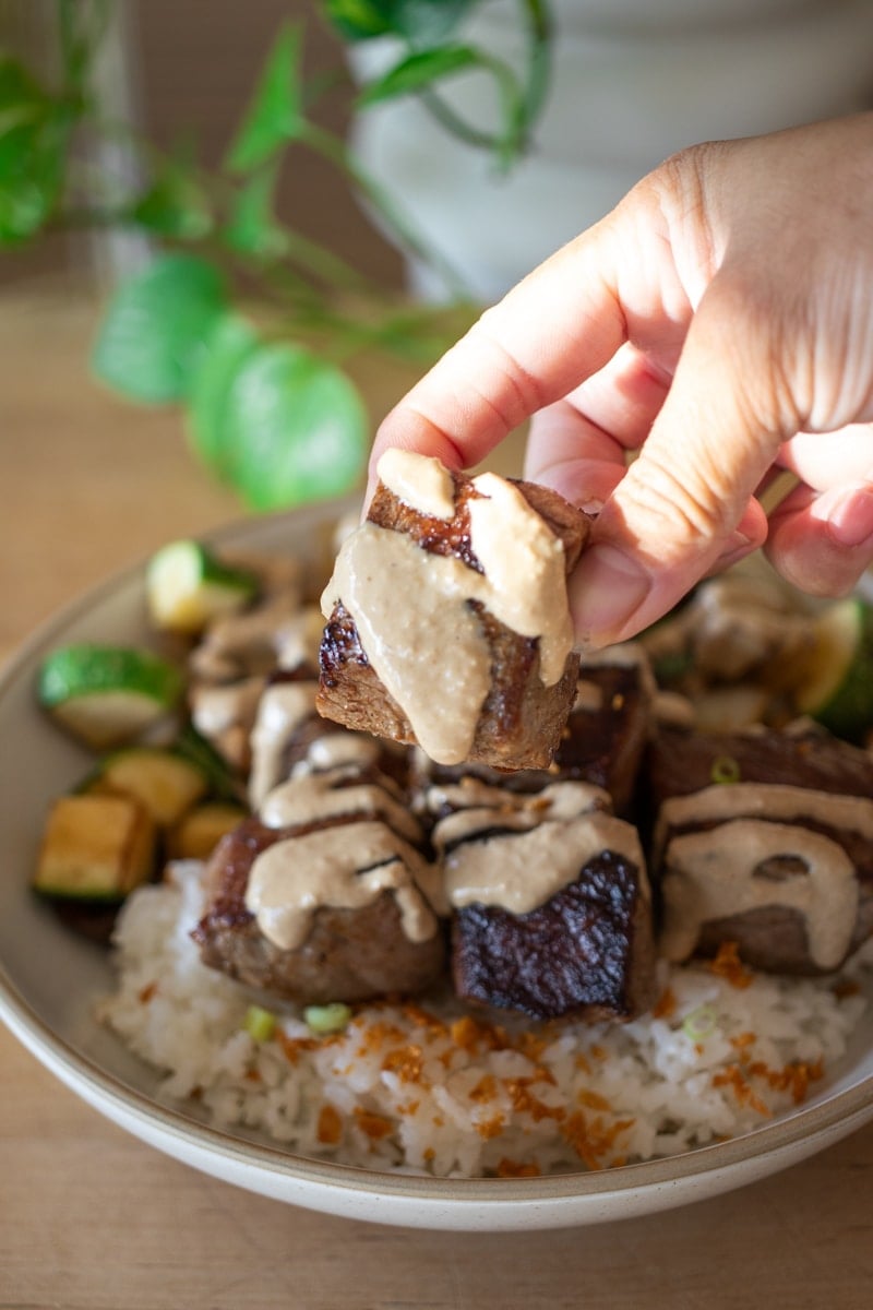 steak hibachi bowl with sauce all over it 