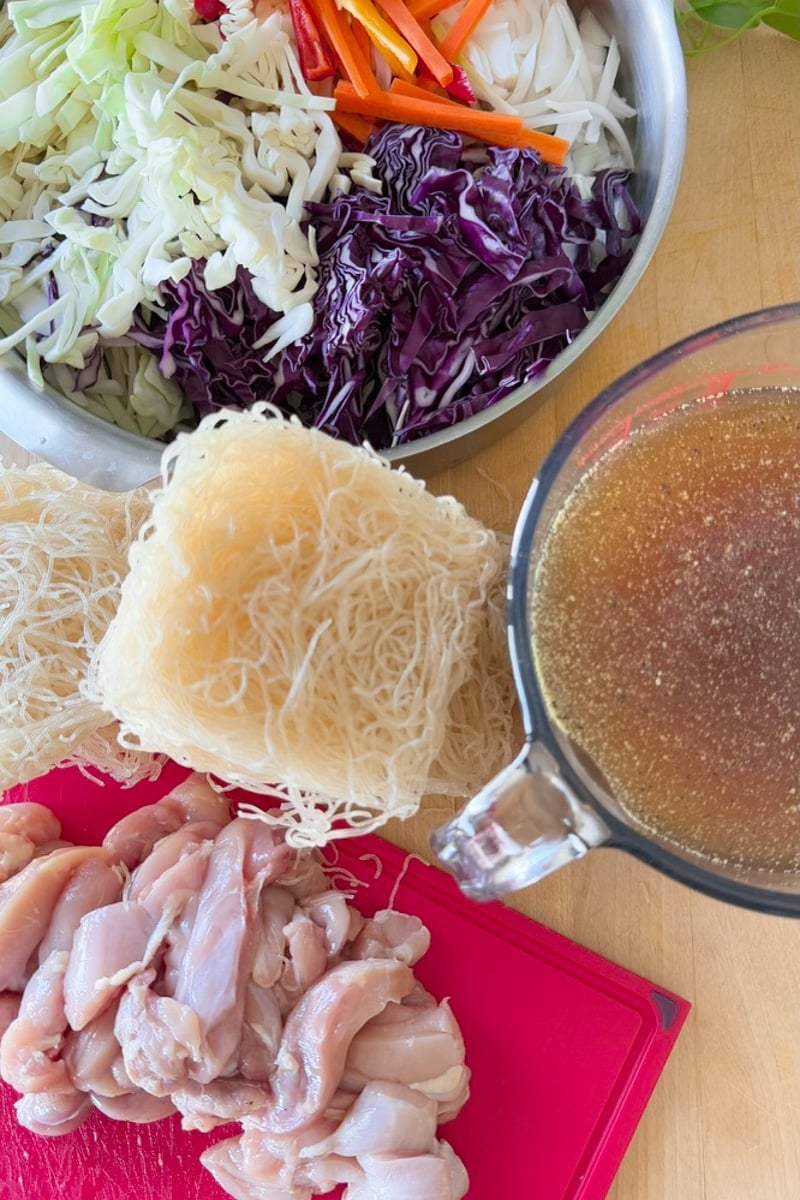 pancit ingredients like bihon noodles, chicken, vegetables and bone broth. 